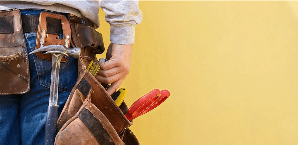 Handyman with tool belt ready for home repairs and maintenance in St Paul, MN