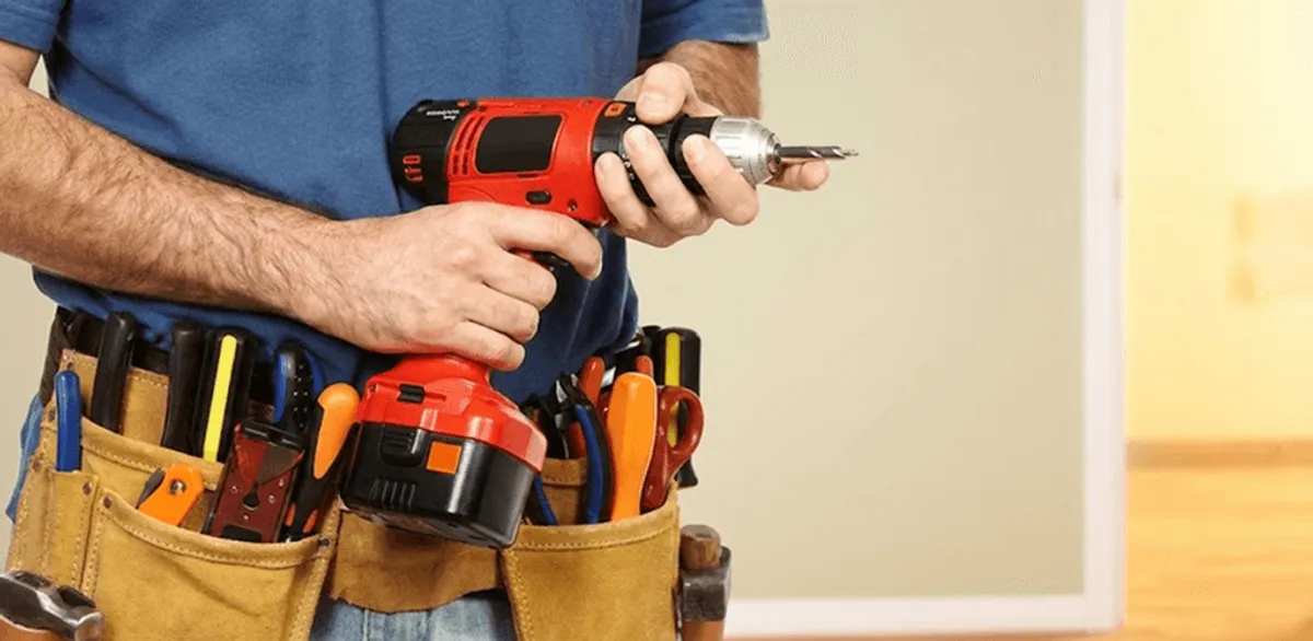 Handyman holding a power drill for home repairs and installations in St Paul, MN